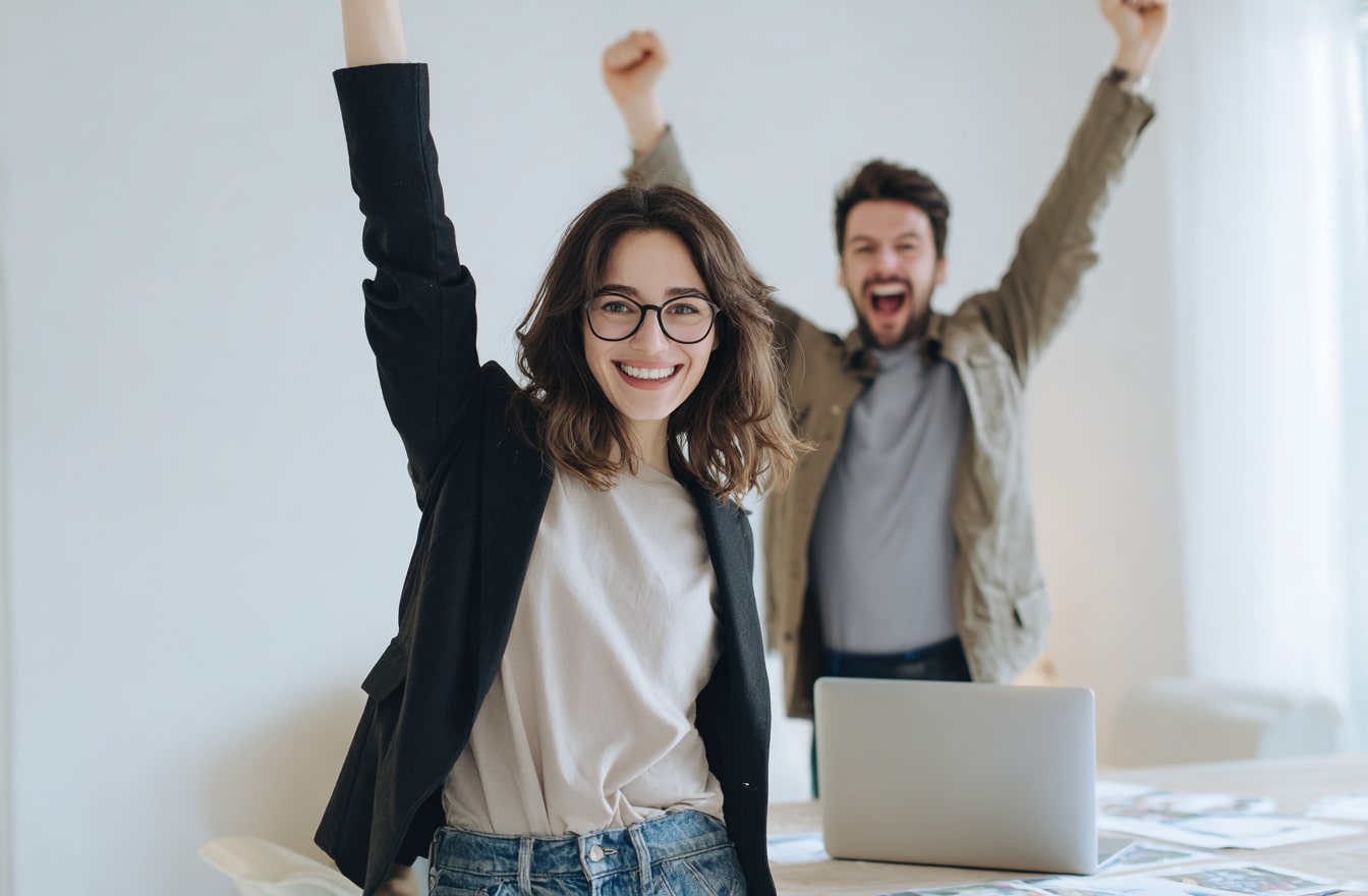 Small business owners celebrating the success of their business that they have experienced while working with Small Business Coach Associates